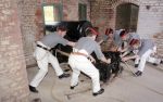 The Portsdown Artillery Volunteers firing the 32pr S.B.B.L. in the North Caponier at Fort Nelson: Traversing the gun